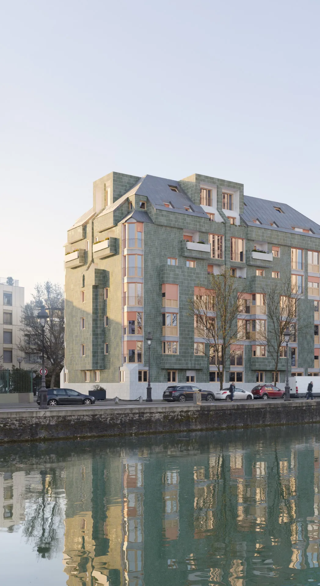 Immeuble de logements en céramique verte au bord du canal